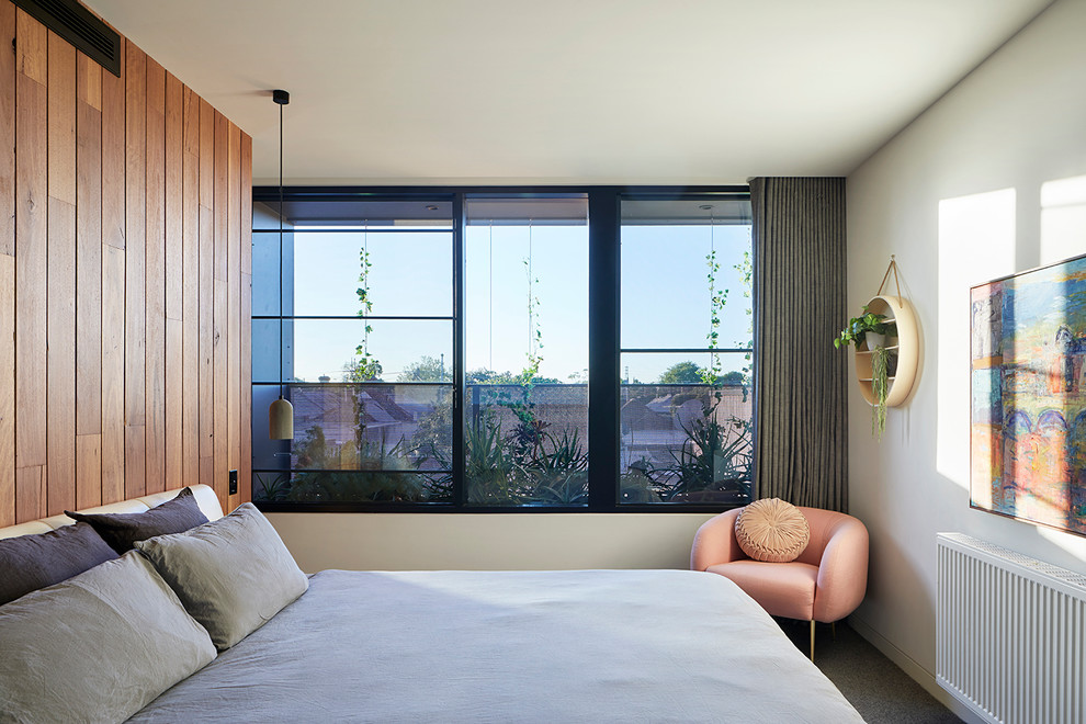 Contemporary guest bedroom in Melbourne with white walls.