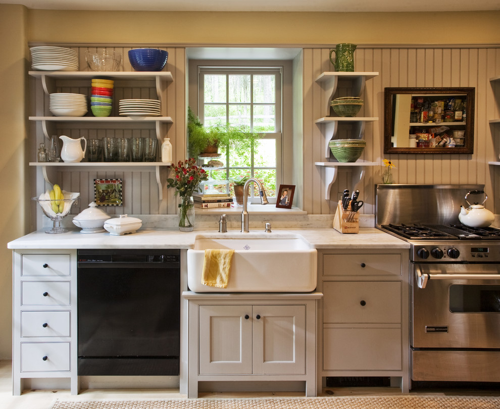 This is an example of a traditional single-wall kitchen in Philadelphia with a farmhouse sink, open cabinets and stainless steel appliances.