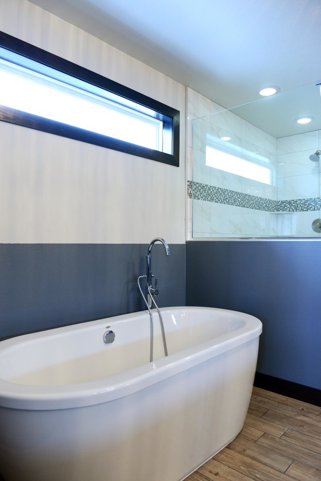 Freestanding bathtub - large transitional master brown tile and ceramic tile porcelain tile freestanding bathtub idea with an undermount sink, shaker cabinets, dark wood cabinets, quartz countertops, a two-piece toilet and gray walls
