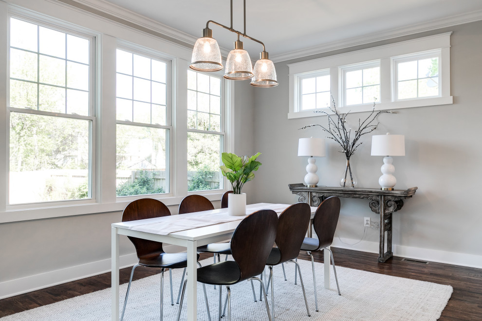 This is an example of a mid-sized arts and crafts separate dining room in Richmond with grey walls, medium hardwood floors, no fireplace and brown floor.