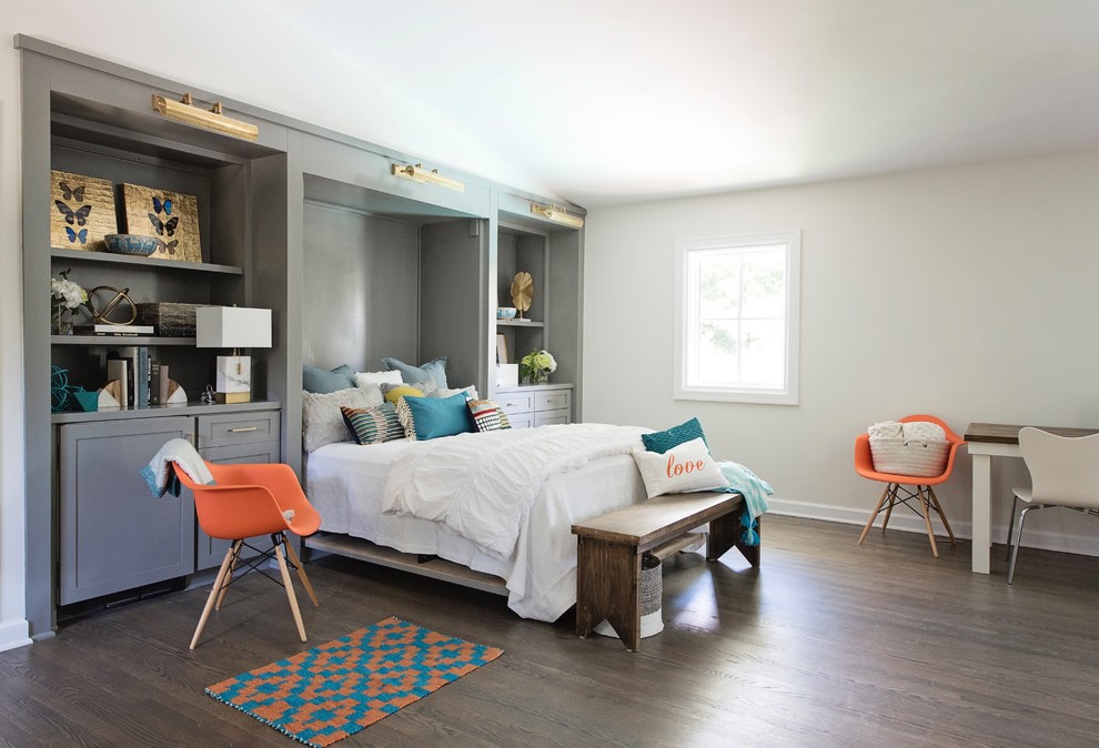 This is an example of a large eclectic guest bedroom in Austin with white walls, medium hardwood floors and brown floor.