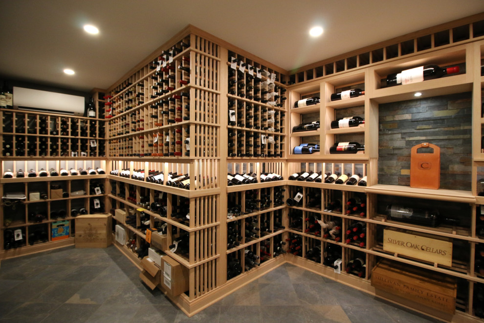 Design ideas for a large traditional wine cellar in Cincinnati with slate floors and display racks.