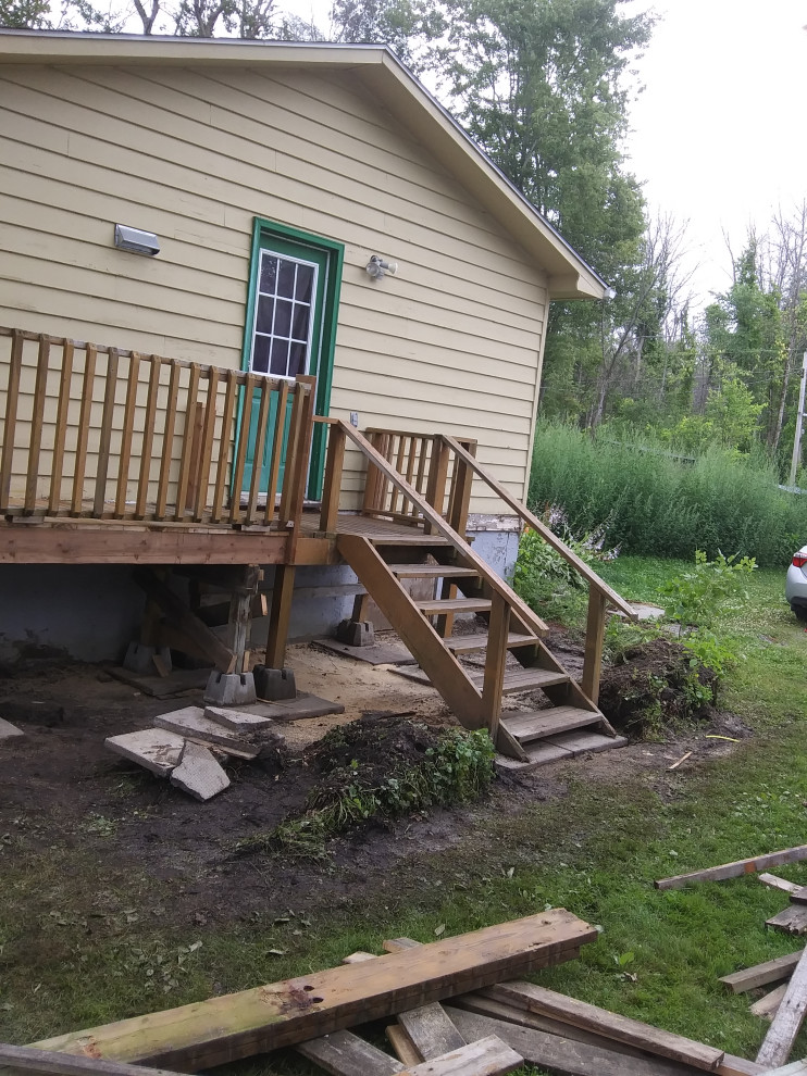 Deck - large transitional backyard wood railing deck idea in Ottawa