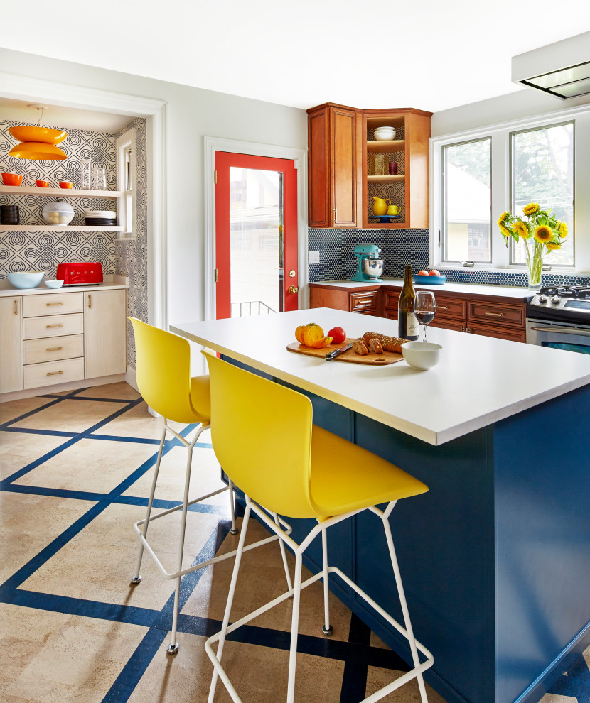 Photo of a medium sized bohemian kitchen in New York with engineered stone countertops, stainless steel appliances, cork flooring, an island, multi-coloured floors, white worktops and blue splashback.
