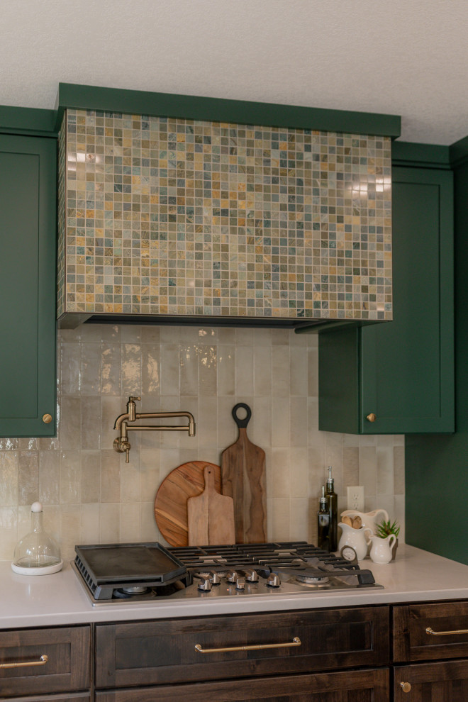 Inspiration for a mid-sized transitional l-shaped light wood floor and brown floor eat-in kitchen remodel with an undermount sink, recessed-panel cabinets, green cabinets, quartz countertops, beige backsplash, terra-cotta backsplash, stainless steel appliances, two islands and beige countertops