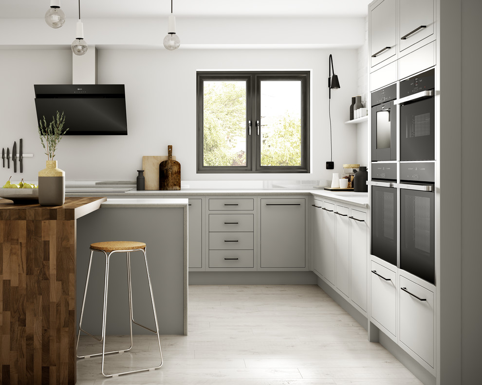 Inspiration for a mid-sized contemporary l-shaped separate kitchen in Other with flat-panel cabinets, grey cabinets, panelled appliances, laminate floors, with island, white splashback and glass sheet splashback.