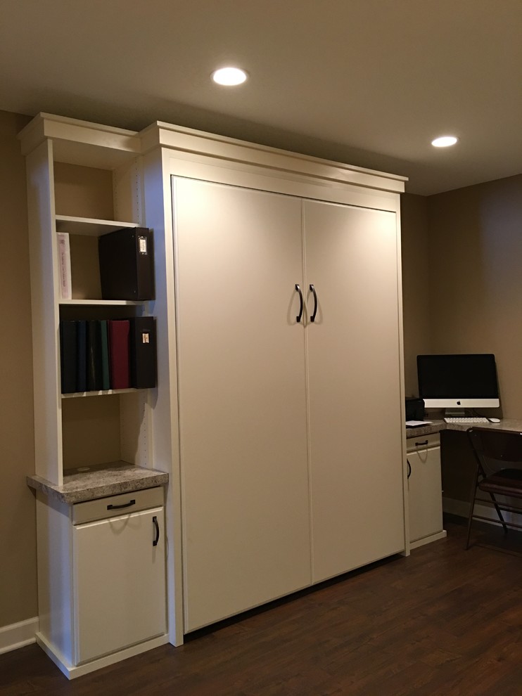 Photo of a mid-sized transitional home office in Minneapolis with beige walls, dark hardwood floors and a built-in desk.