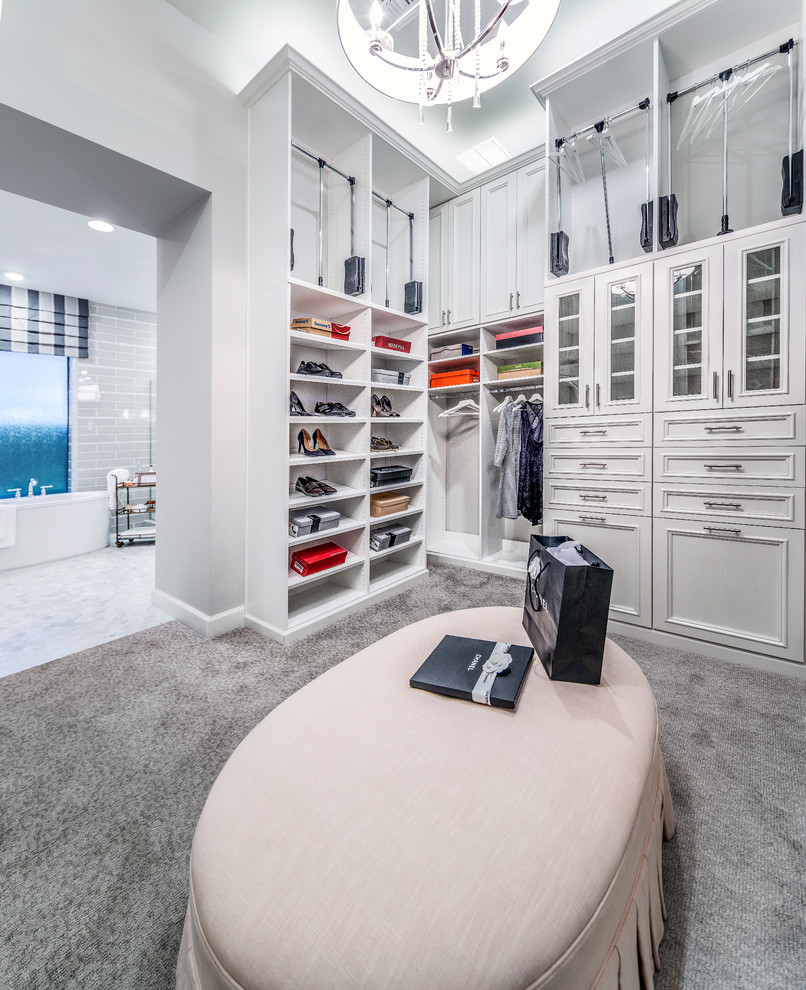 Inspiration for a mid-sized traditional women's dressing room in Denver with white cabinets, carpet, grey floor and recessed-panel cabinets.