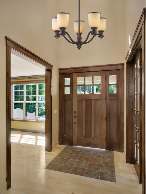 Design ideas for a mid-sized transitional foyer in New York with beige walls, granite floors, a single front door and a medium wood front door.