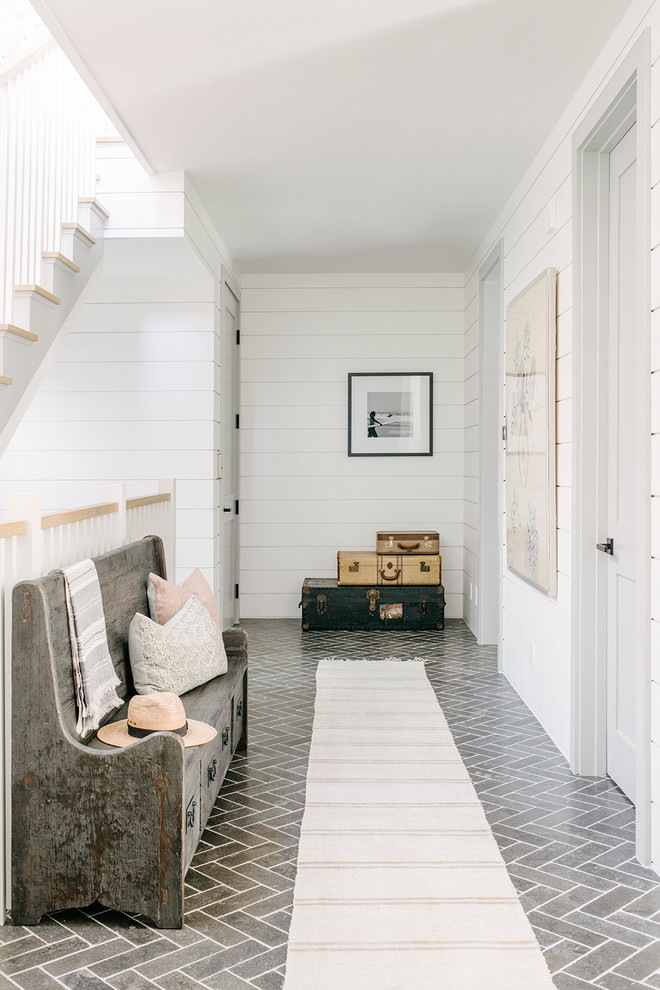 Photo of a beach style hallway in Los Angeles with white walls and grey floor.
