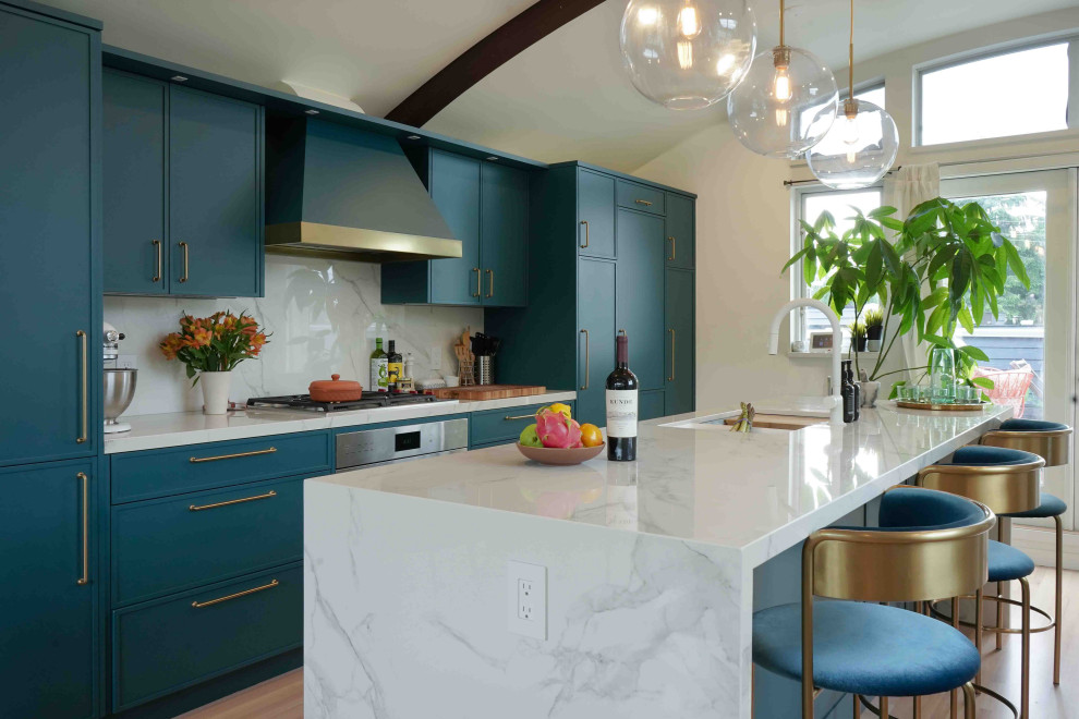 Medium sized modern galley kitchen/diner in Vancouver with a double-bowl sink, flat-panel cabinets, turquoise cabinets, marble worktops, white splashback, marble splashback, integrated appliances, light hardwood flooring, an island, beige floors, white worktops and a wood ceiling.