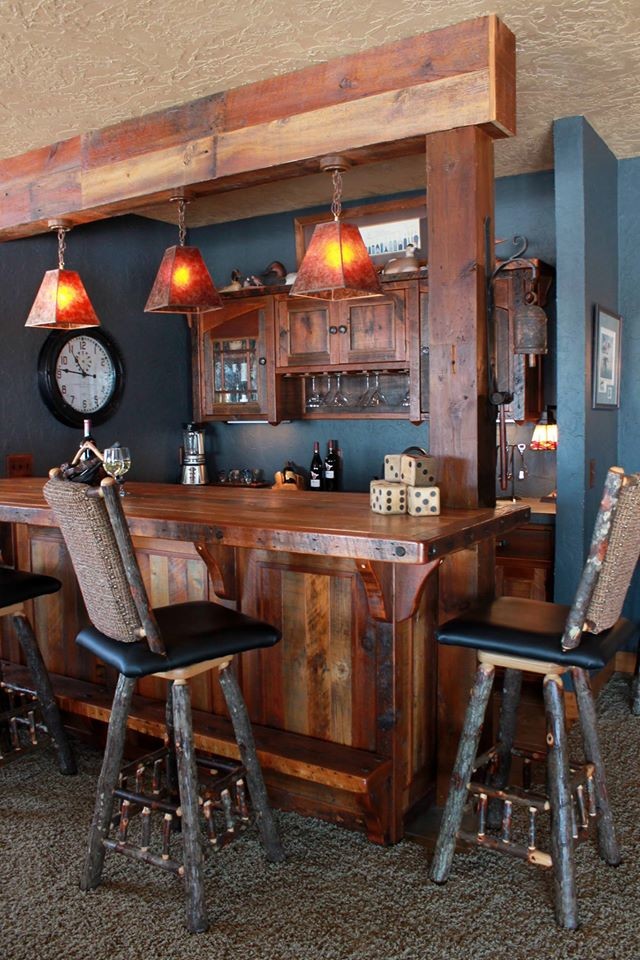 This is an example of a small country galley seated home bar in Other with shaker cabinets, dark wood cabinets, wood benchtops, blue splashback, carpet and brown benchtop.