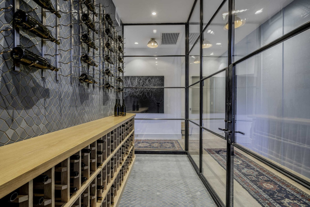 Mid-sized contemporary wine cellar in Los Angeles with ceramic floors, display racks and grey floor.