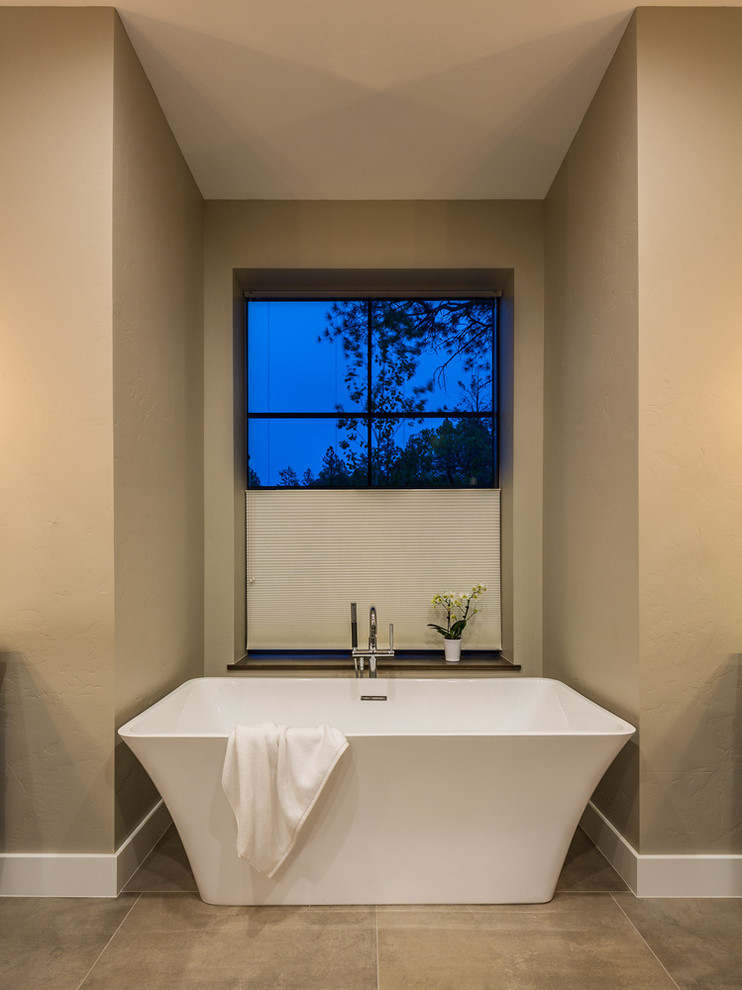 Mid-sized transitional master bathroom in Other with a freestanding tub, beige walls, ceramic floors and beige floor.