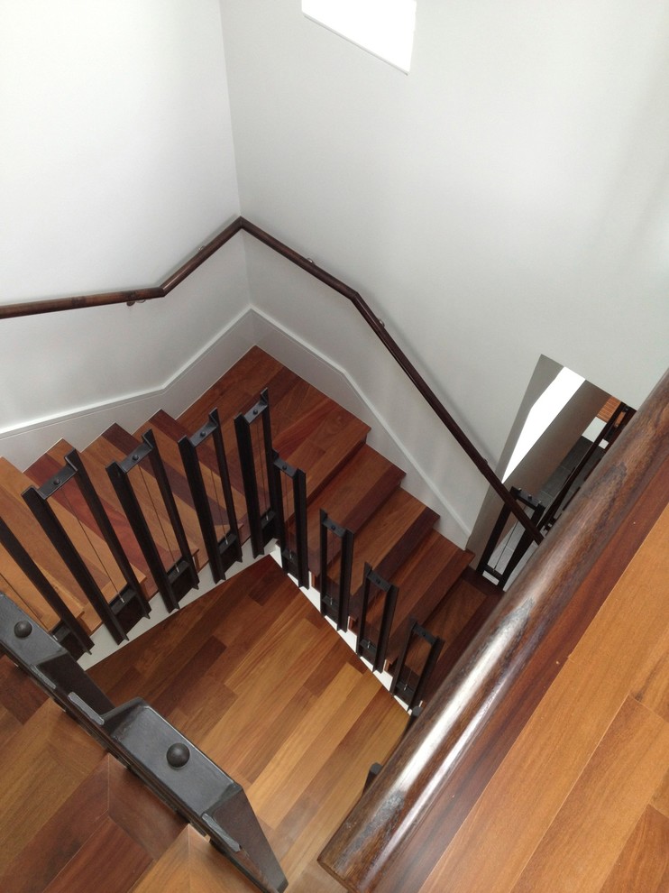 Inspiration for a mid-sized modern wood straight staircase in Houston with open risers and mixed railing.
