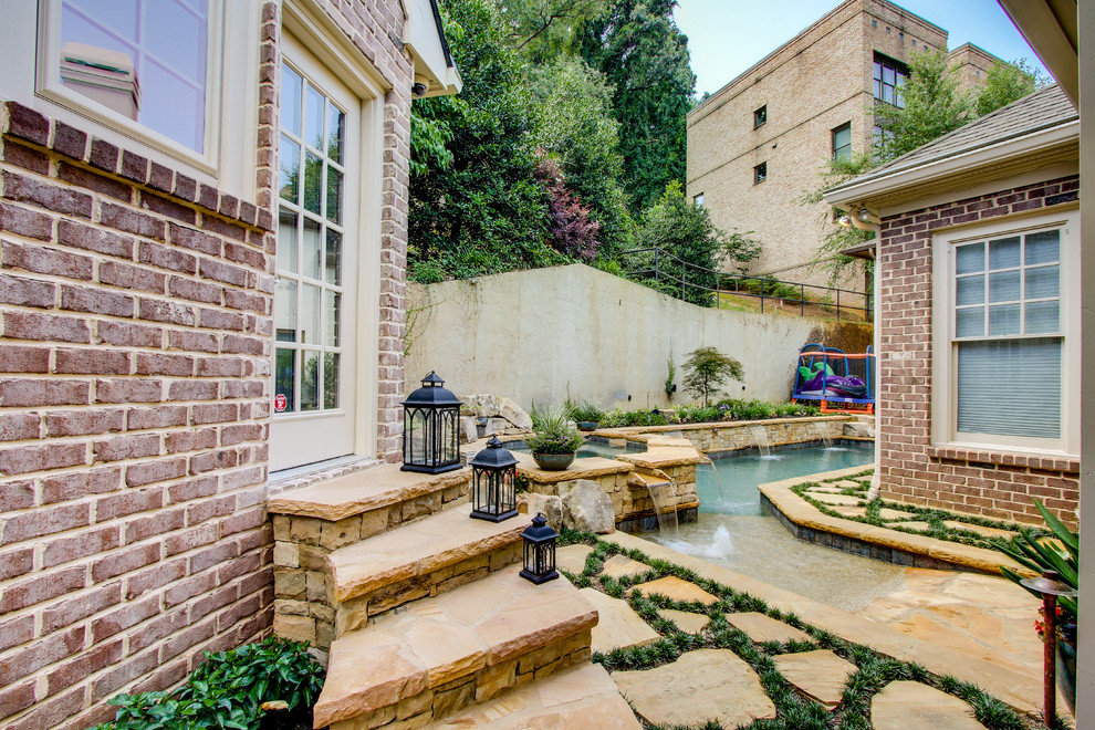 Mid-sized transitional backyard rectangular lap pool in Atlanta with a hot tub and natural stone pavers.