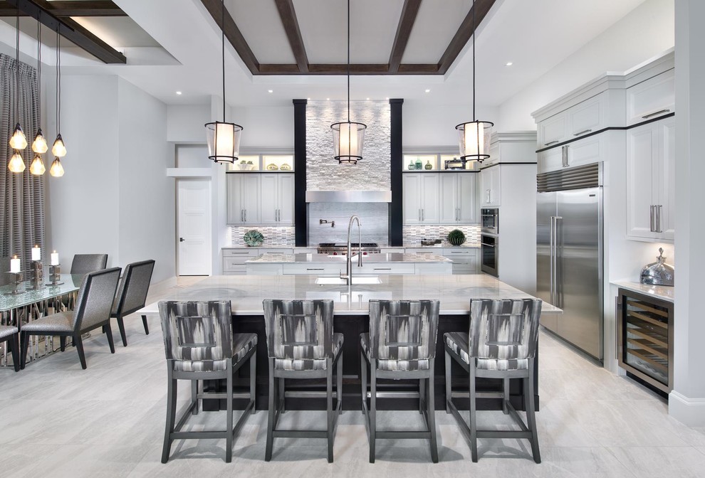 Photo of a mid-sized contemporary l-shaped eat-in kitchen in Miami with white cabinets, stainless steel appliances, multiple islands, an undermount sink, recessed-panel cabinets, marble benchtops, multi-coloured splashback, porcelain splashback, porcelain floors and grey floor.
