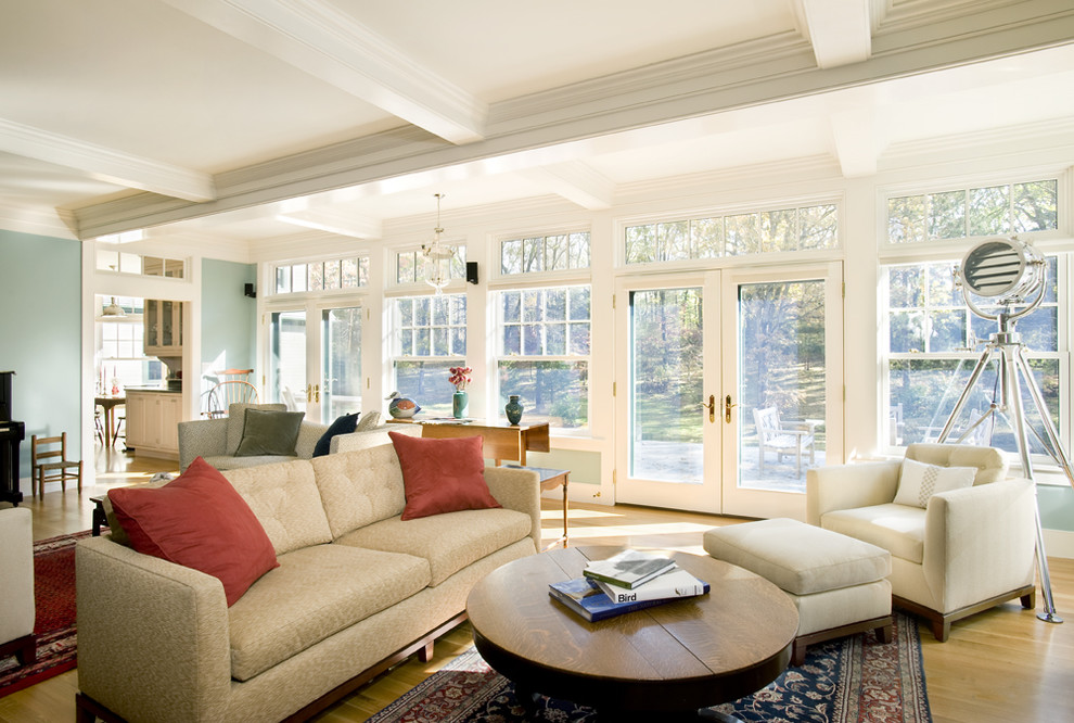 Inspiration for a traditional family room in Boston with blue walls and medium hardwood floors.
