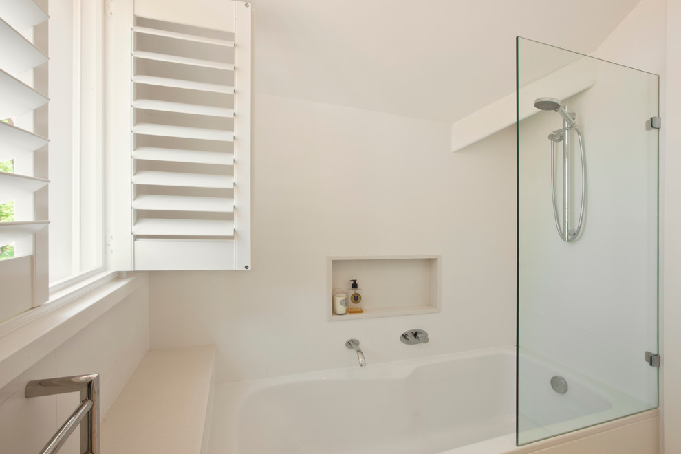 Photo of a large transitional kids bathroom in Sydney with a drop-in tub, a shower/bathtub combo, white tile, ceramic tile and white walls.