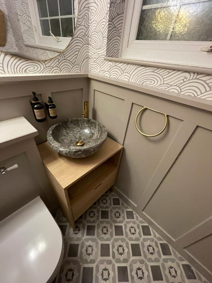 Small traditional cloakroom in Surrey with open cabinets, light wood cabinets, a one-piece toilet, ceramic flooring, wooden worktops, grey floors, a freestanding vanity unit, a vaulted ceiling and panelled walls.