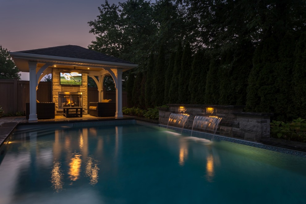 Pool - transitional backyard pool idea in Toronto
