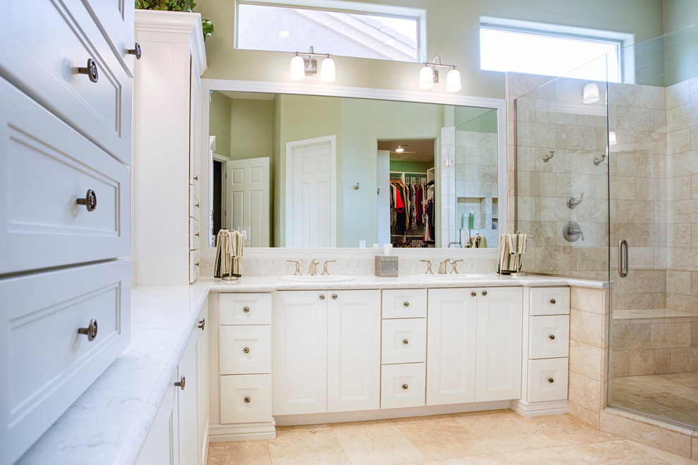 Large transitional master beige tile and travertine tile travertine floor corner shower photo in Phoenix with recessed-panel cabinets, white cabinets, green walls, an undermount sink and granite countertops