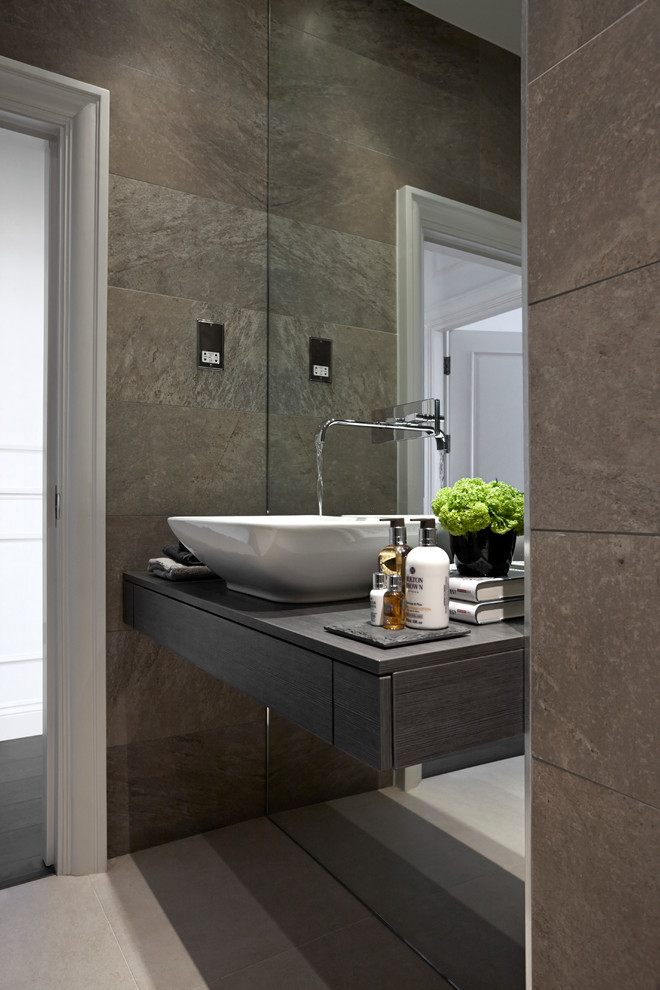 Contemporary bathroom in London with dark wood cabinets, an open shower, a wall-mount toilet, brown tile, porcelain tile and porcelain floors.