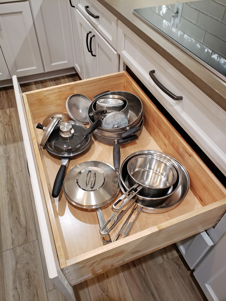Inspiration for a mid-sized transitional l-shaped vinyl floor and brown floor eat-in kitchen remodel in Nashville with a farmhouse sink, recessed-panel cabinets, gray cabinets, quartz countertops, gray backsplash, ceramic backsplash, stainless steel appliances, an island and brown countertops