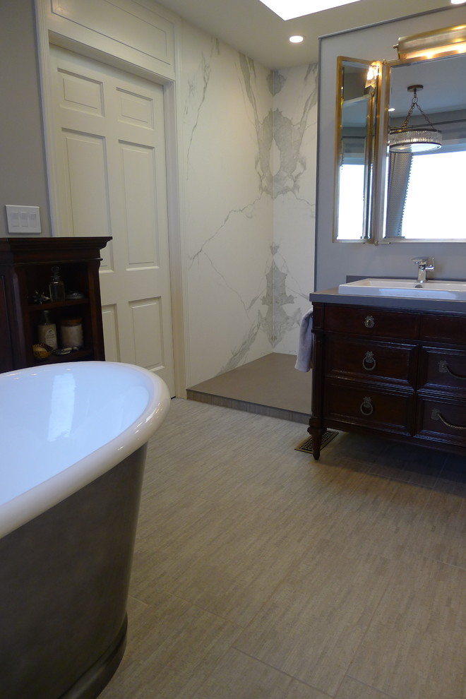 Freestanding bathtub - large transitional master gray tile and porcelain tile porcelain tile freestanding bathtub idea in Indianapolis with a drop-in sink, furniture-like cabinets, dark wood cabinets, solid surface countertops, a one-piece toilet and gray walls