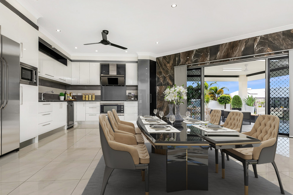 Inspiration for a large modern l-shaped open plan kitchen in Darwin with a drop-in sink, flat-panel cabinets, white cabinets, white splashback, glass sheet splashback, stainless steel appliances, porcelain floors, no island, white floor, black benchtop and quartzite benchtops.