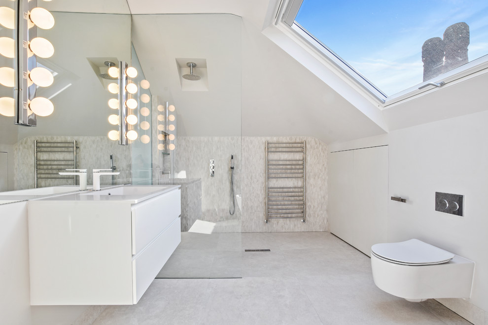 Inspiration for a contemporary bathroom in London with flat-panel cabinets, white cabinets, a curbless shower, a wall-mount toilet, white tile, white walls, an integrated sink, white floor, an open shower and white benchtops.