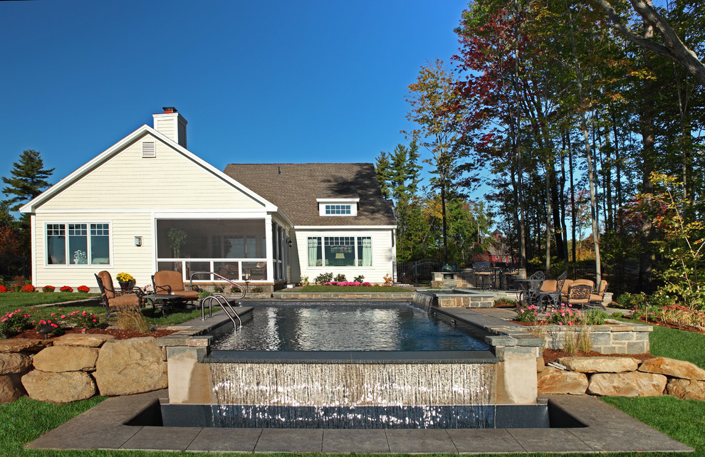 This is an example of a traditional backyard rectangular pool in New York with natural stone pavers.