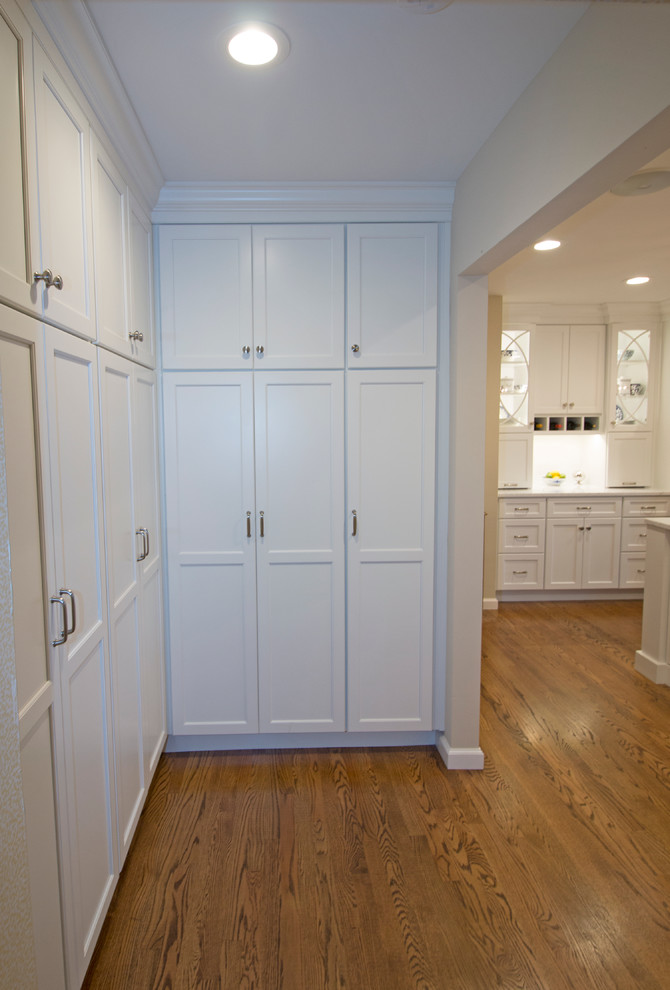 Example of a huge transitional medium tone wood floor open concept kitchen design with an undermount sink, shaker cabinets, white cabinets, marble countertops, white backsplash, ceramic backsplash, stainless steel appliances and two islands