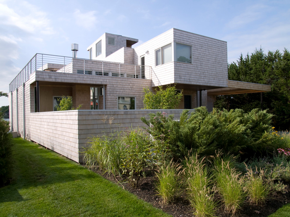 This is an example of a contemporary two-storey exterior in New York with wood siding.