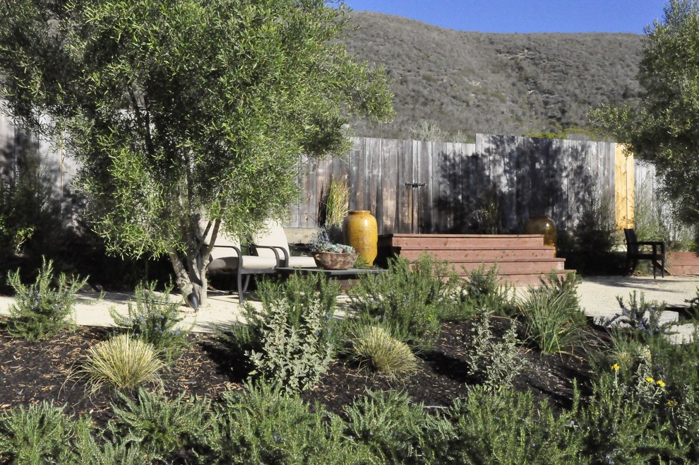 This is an example of a mediterranean backyard garden in San Luis Obispo with gravel.