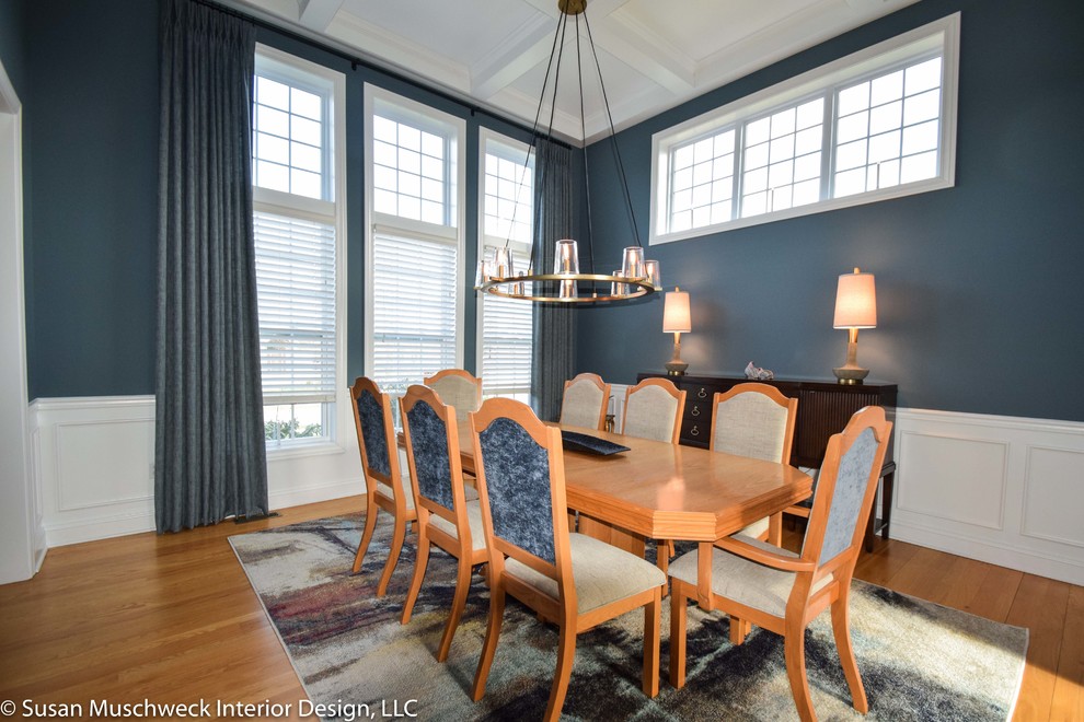 Inspiration for a mid-sized transitional light wood floor enclosed dining room remodel with blue walls