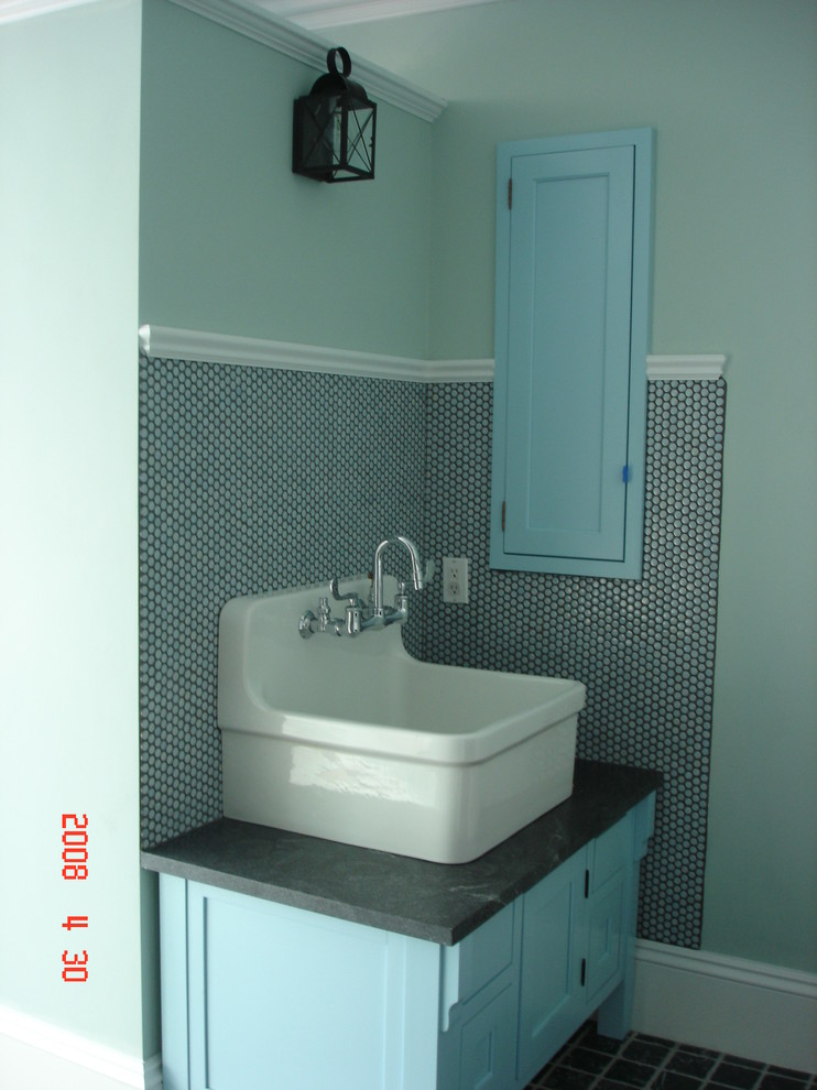 Photo of a mid-sized transitional master bathroom in Boston with a vessel sink, shaker cabinets, dark wood cabinets, soapstone benchtops, a freestanding tub, a one-piece toilet, blue tile, glass tile, blue walls and ceramic floors.