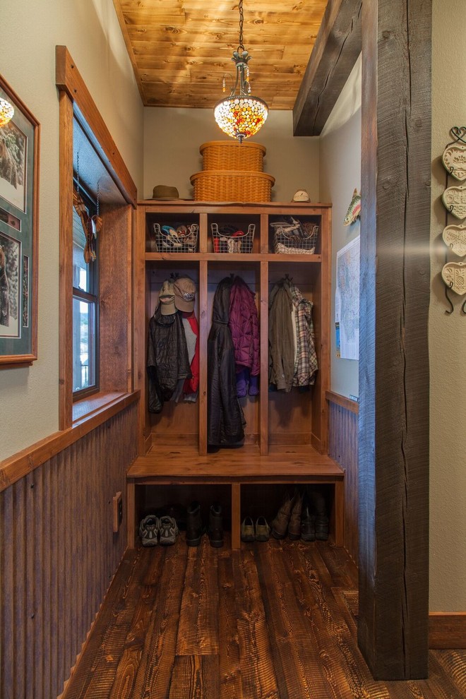 Mudroom - small rustic dark wood floor mudroom idea with beige walls