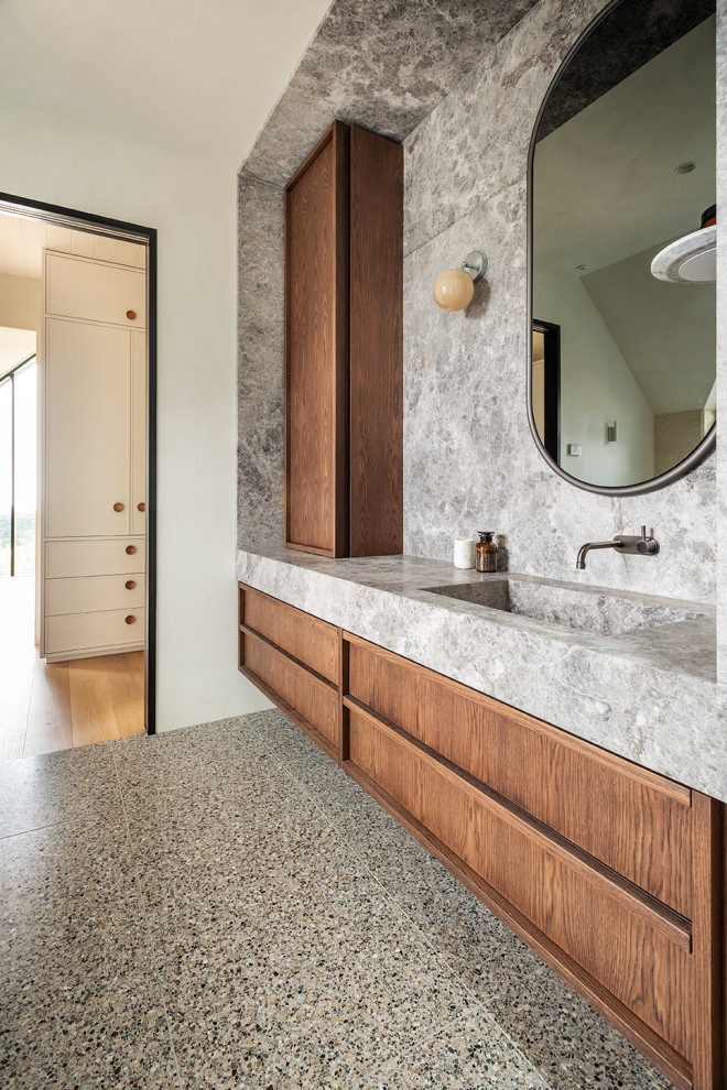 Large contemporary ensuite bathroom in Melbourne with flat-panel cabinets, medium wood cabinets, white walls, terrazzo flooring, an integrated sink, limestone worktops, multi-coloured floors, grey worktops, a single sink and a built in vanity unit.