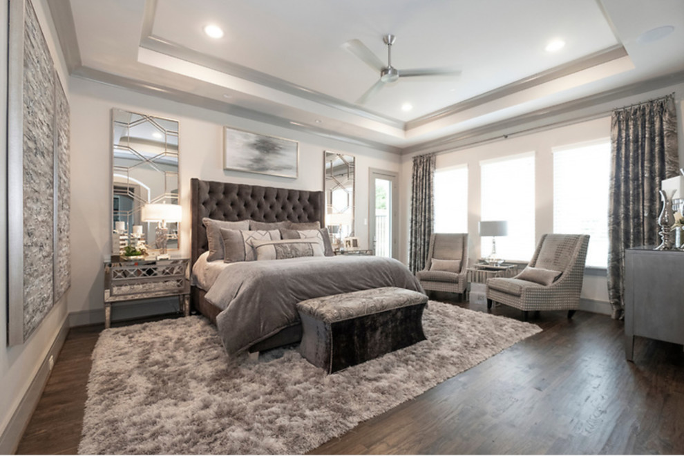 This is an example of a modern master bedroom in Dallas with grey walls, dark hardwood floors and brown floor.