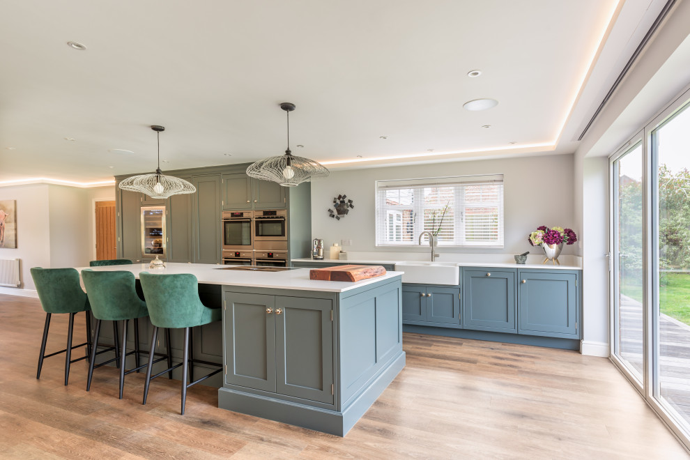 Inspiration for a large transitional single-wall open plan kitchen in Sussex with with island.