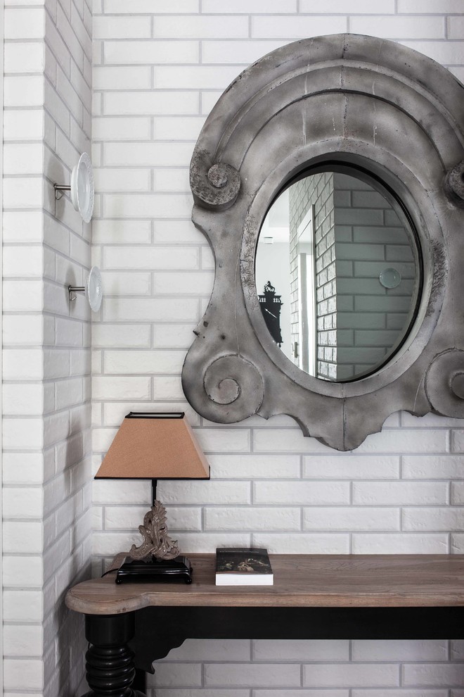 Eclectic entryway in Moscow with white walls.