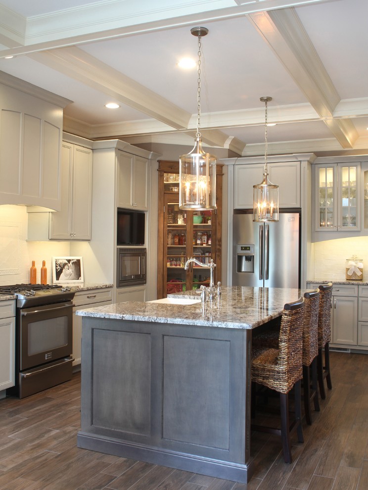 Inspiration for a large transitional l-shaped porcelain tile eat-in kitchen remodel with a farmhouse sink, granite countertops, white backsplash, ceramic backsplash, white appliances and an island
