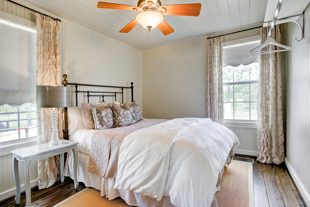 Traditional bedroom in Houston with white walls, dark hardwood floors and brown floor.