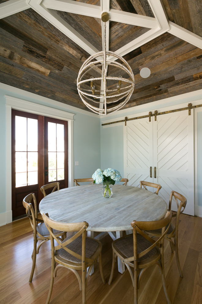 Design ideas for a large country separate dining room in Charleston with blue walls, medium hardwood floors, brown floor and no fireplace.