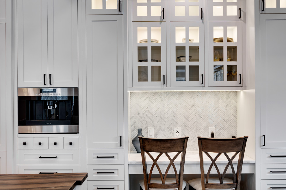 Inspiration for a huge transitional u-shaped dark wood floor and brown floor kitchen remodel in Calgary with shaker cabinets, white cabinets, marble countertops, gray backsplash, marble backsplash, stainless steel appliances, an island and white countertops