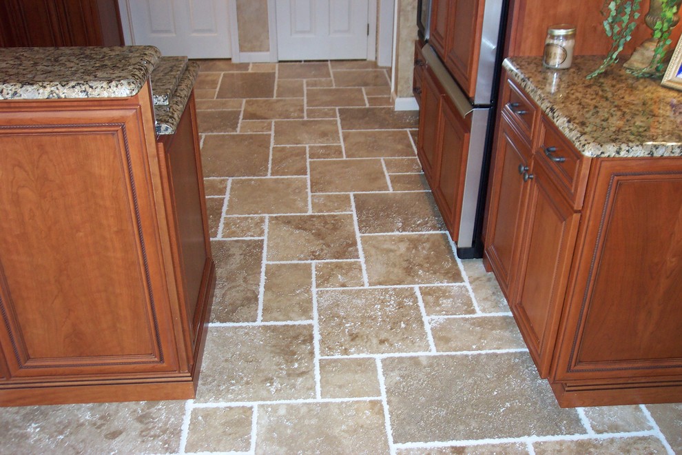 Kitchen pantry - transitional l-shaped porcelain tile kitchen pantry idea with a double-bowl sink, recessed-panel cabinets, medium tone wood cabinets, granite countertops, beige backsplash, stone tile backsplash, stainless steel appliances and no island