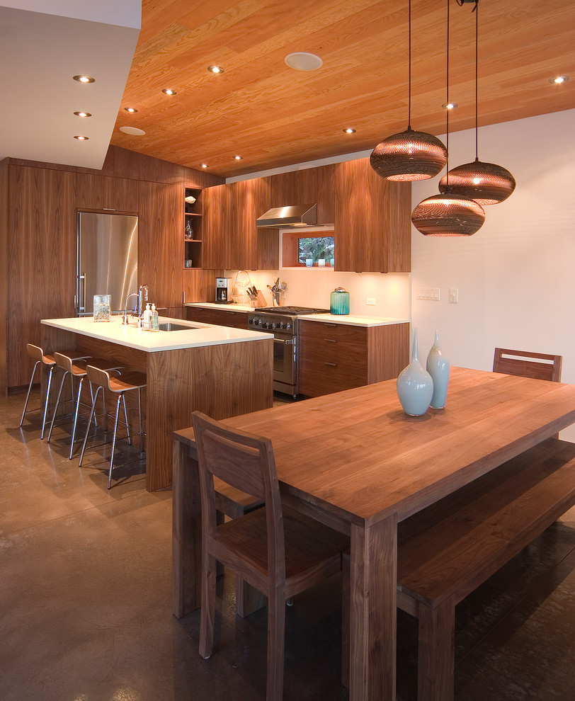 Photo of a contemporary eat-in kitchen in Seattle with an undermount sink, flat-panel cabinets and medium wood cabinets.