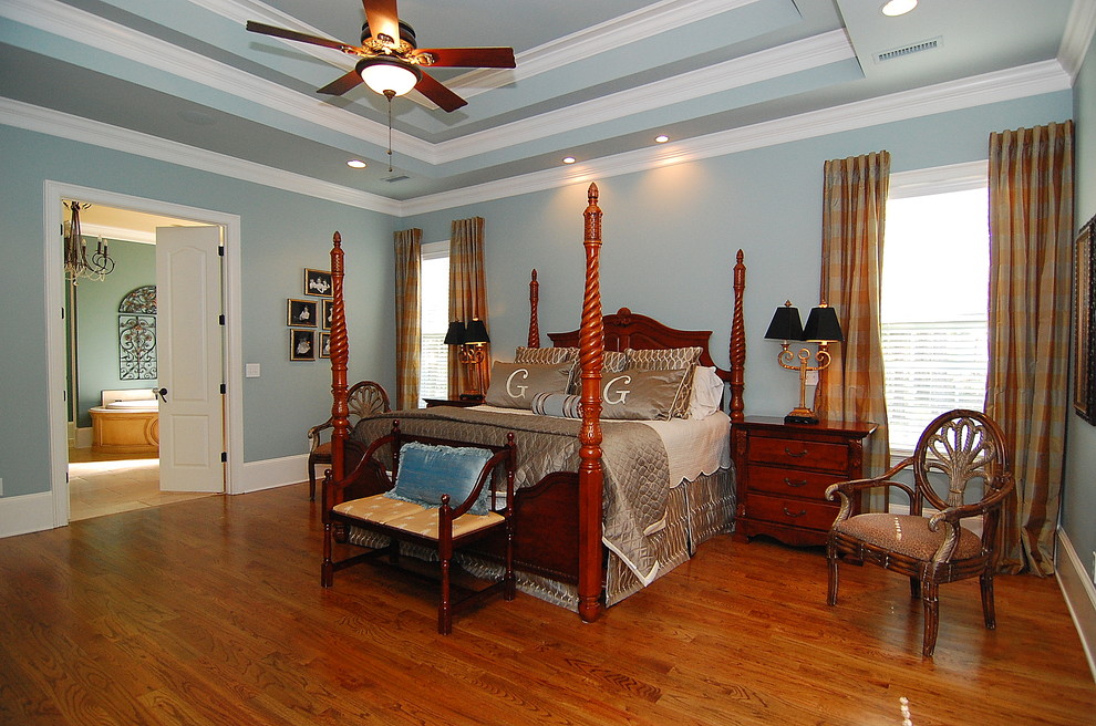 Inspiration for a large traditional master bedroom in Charleston with grey walls, dark hardwood floors, no fireplace and brown floor.