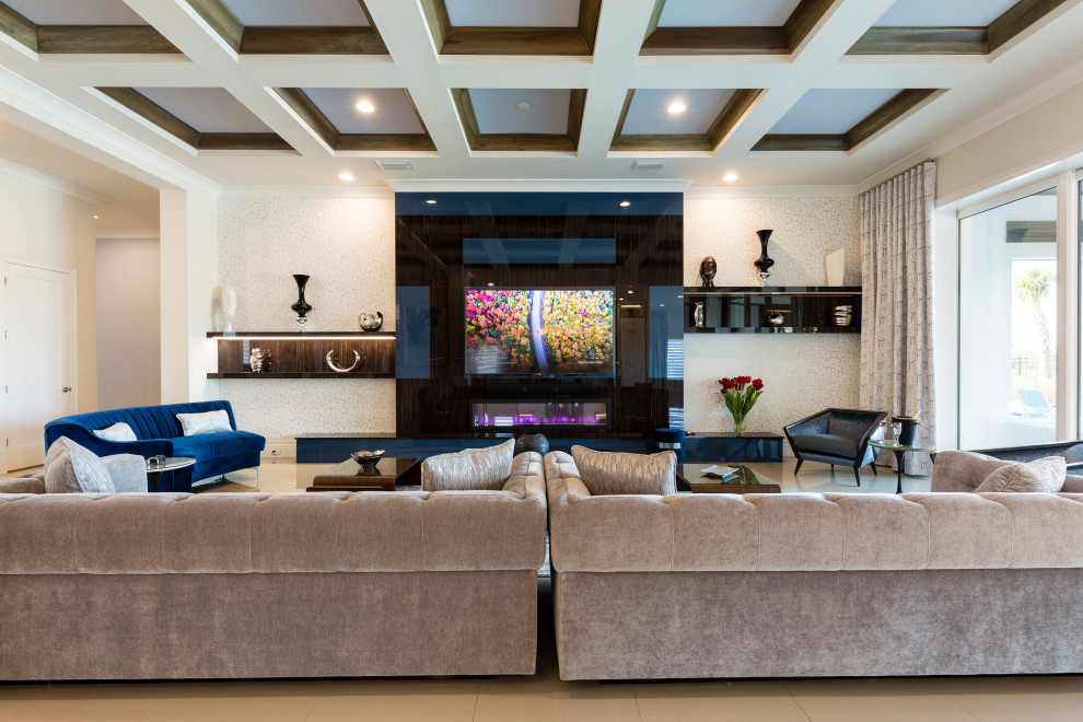 Photo of an expansive contemporary open concept family room in Orlando with white walls, porcelain floors, a standard fireplace, a wood fireplace surround, a wall-mounted tv and beige floor.